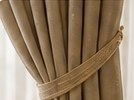 Neutral drapes and curtain tieback